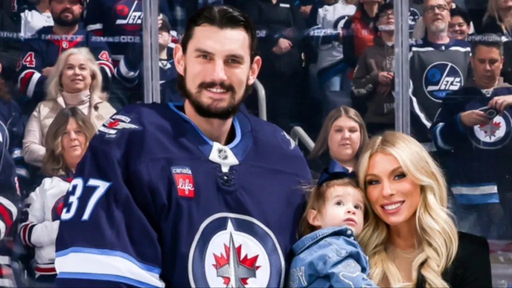 Conor Hellebuyck with his wife and kid